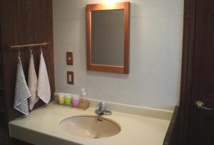 a bathroom with a sink and a mirror at Guesthouse Coteau - Vacation STAY 5450 in Biei
