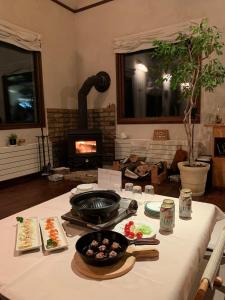 a table with food on it with a fireplace at Guesthouse Coteau - Vacation STAY 5450 in Biei