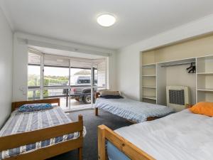 a bedroom with two beds and a window at Sunset Strip 4 in Torquay