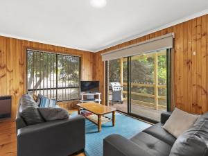 a living room with a couch and a table at Muirfield Beach Unit 1-23 in Torquay