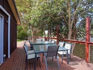 a patio with a table and chairs on a deck at Great Ocean Retreat 43 in Torquay +6 photos