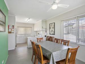 a kitchen and dining room with a table and chairs at Coffey Court Cottage 2 in Torquay +5 photos
