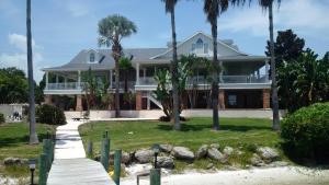 a house on the beach with palm trees at Pineda Palms Estate, 4 BR for 13 guests, heated pool in Melbourne