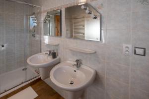 a bathroom with a sink and a toilet and a mirror at Penzion Na Vyhlídce in Frýdlant nad Ostravicí +87 photos