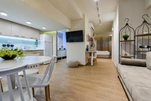 a kitchen and living room with a table and a couch at BLACKHAUS Apartments in Thessaloniki