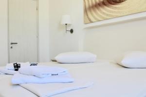 two white towels sitting on top of a bed at Aegeo Inn in Antiparos