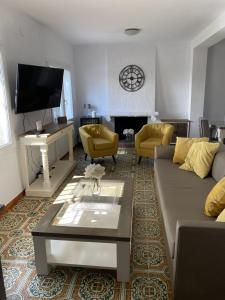 a living room with a couch and a tv at VILLA CATALUNYA in Cambrils