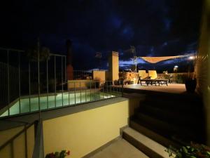 a view of a swimming pool at night at Bel's Home in Sant Feliu de Guixols