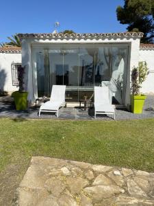 a group of white chairs sitting on a patio at VILLA CATALUNYA in Cambrils