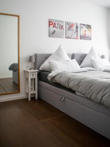 a bedroom with a large bed with a mirror at unique flat in Düsseldorf