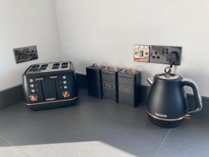 a kitchen with a stove and a tea kettle at The Grasslands Holiday Home, in Cork