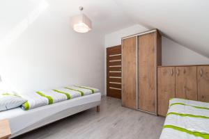 Postel nebo postele na pokoji v ubytování Apartament Perła + 5 fotografií