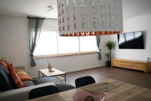 a living room with a couch and a table at unique flat in Düsseldorf +9 photos