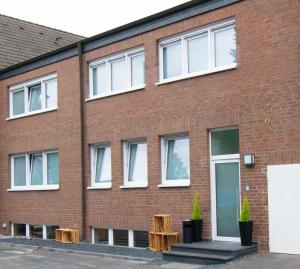 a red brick building with white windows at unique flat in Düsseldorf