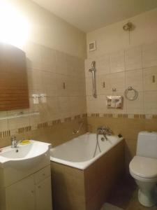a bathroom with a tub and a toilet and a sink at Minimax in Odesa