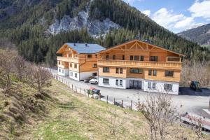 a large wooden house in the middle of a mountain at Gleiming apartments in Schladming