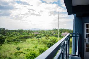 a balcony with a view of a field at Lux Suites Nanyuki Business Apartment in Nanyuki