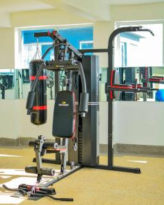 a gym with a bench and a weight machine at Lux Suites Nanyuki Business Apartment in Nanyuki