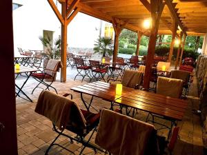 a group of tables and chairs in a restaurant at Hotel Restaurant Unikat in Zeltingen-Rachtig