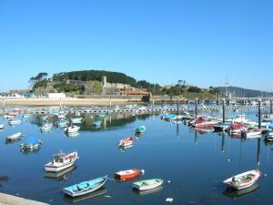 a bunch of boats are docked in a harbor at Hostal Alce in Nigrán