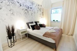 Ένα ή περισσότερα κρεβάτια σε δωμάτιο στο M&K Apartamenty Cztery Brzozy - Wyspa Sobieszewska