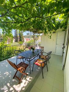 a patio with a table and chairs on a balcony at Apartments Mare in Mlini