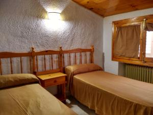 Postel nebo postele na pokoji v ubytování Pensión Rural Arroyo la Teja