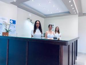 two women standing at a counter in a room at Hotel Fotini in Mytikas