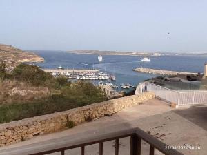 a view of a marina with boats in the water at Felluga harbour view in Qala