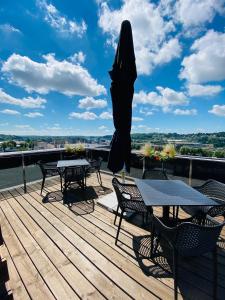 a patio with tables and chairs on a deck at IBIS Styles Kaunas Centre in Kaunas