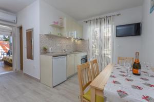 a kitchen and dining room with a table and a dining room at Apartments Sanja in Hvar