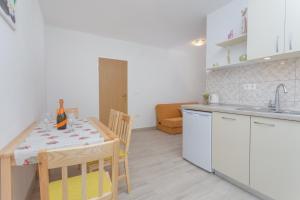 a kitchen with a table with a bottle of wine on it at Apartments Sanja in Hvar