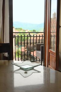 a book sitting on top of a table with a window at Il sasso bed & breakfast in Sasso di Castalda