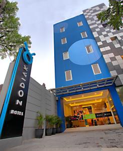 a blue hotel with a sign in front of it at Zodiak Paskal by KAGUM Hotels in Bandung