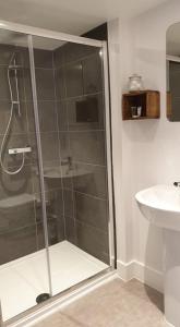 a shower stall in a bathroom with a sink at Argyll House Bed and Breakfast in Westleton