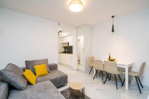 a living room with a couch and a table with yellow pillows at Luxury Downtown West Apartment Dubrovnik in Dubrovnik