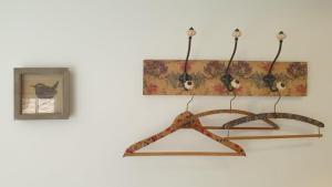 a wooden hanger hanging on a wall with a picture at Argyll House Bed and Breakfast in Westleton