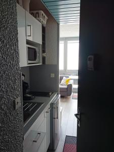 a kitchen with a stove and a microwave at Résidence cambielh in Aragnouet