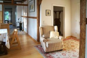 a living room with a chair and a table at Ferienhof Möltgen in Bosau