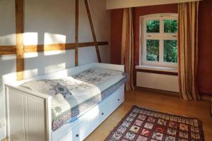 a bedroom with a bed and a window at Ferienhof Möltgen in Bosau