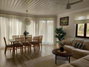 a living room with a table and chairs and a couch at Maritima's Home in Łukęcin