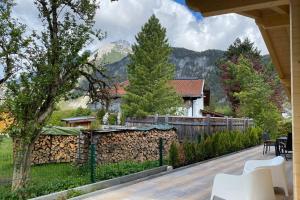 a backyard with a fence and a wooden deck at Karwendel Chalet in Scharnitz
