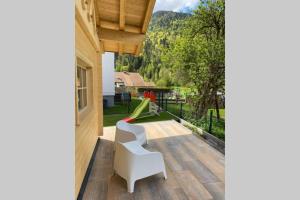 a patio with a slide and a playground at Karwendel Chalet in Scharnitz