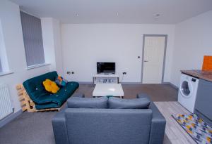 a living room with a couch and a table at Cosy Executive City Apartment 2 in Doncaster