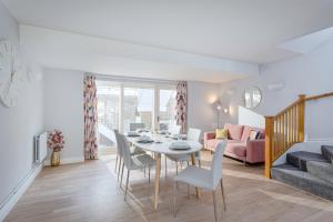 a dining room and living room with a table and chairs at 3 Bedroom Jesus Green Townhouse with Parking in Cambridge