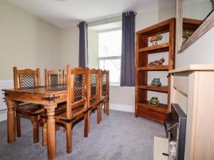 a dining room with a wooden table and chairs at Pendeen in Par