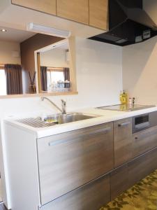 a kitchen with a sink and a mirror at Harbour Inn & Suites - Vacation STAY 8829 in Niigata