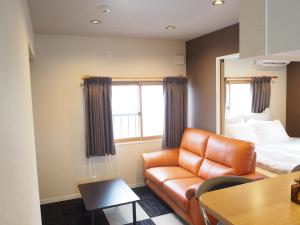 a living room with a couch and a bed at Harbour Inn & Suites - Vacation STAY 8829 in Niigata