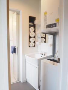 a white kitchen with a sink and a counter at Harbour Inn & Suites - Vacation STAY 8829 in Niigata