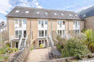 an exterior view of a house with a patio at 3 Bedroom Jesus Green Townhouse with Parking in Cambridge